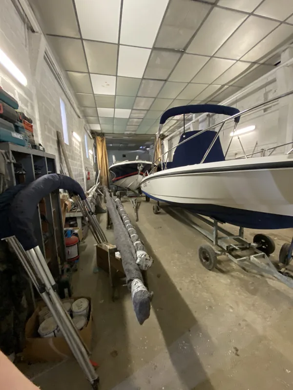 L’atelier : un bateau sur sa remorque, un mât couché